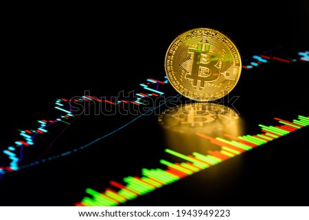 Coin with Bitcoin symbol on chart market prices