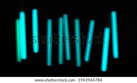 Bright blue wands on a dark background close up