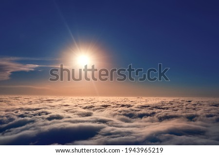 The sun shines above the clouds