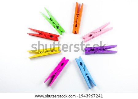 Colorful wooden clothespins on white background. Close up, copy space.