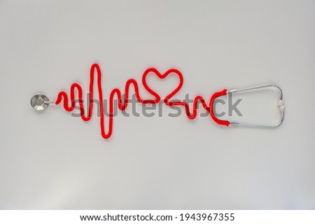 Stethoscope forming heartbeat with its cord. Healthcare concept. World Heart Day. Space for text. Soft focus. Top view. Royalty-Free Stock Photo #1943967355
