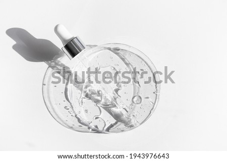 Transparent liquid gel or hyaluronic serum acid in petri medical dish with pipette. Hydrating and skin care concept Royalty-Free Stock Photo #1943976643