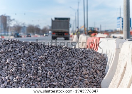 A pile of rubble on the road and the  blurred truck on background
