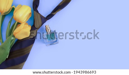 tie, bottle of perfume on a colored background