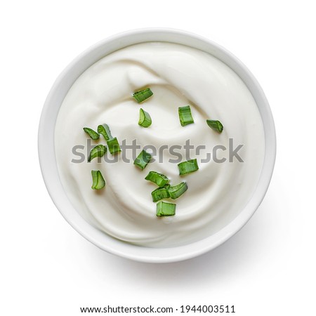 bowl of sour cream with green onions isolated on white background, top view Royalty-Free Stock Photo #1944003511