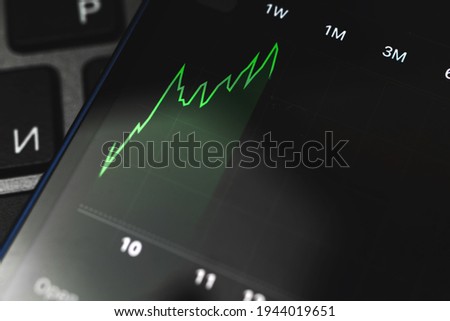 Financial chart with uptrend line close-up, stock market on the screen, business background photo