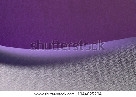 Macro image of purple paper with shadow effect and selective focus. Abstract geometric background. Copy space.