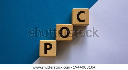 POC, people of color symbol. Wooden cubes with the word POC, people of color. Beautiful white and blue background. Business and POC, people of color concept, copy space.