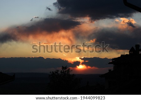 Beautiful sunset over the silhouette of a medieval city 