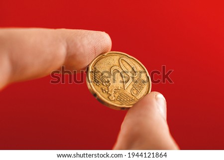 Twenty euro cent coin close up view in man hand