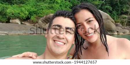 A loving couple doing a selfie in the sea on a hot summer day