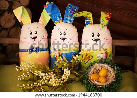 Easter decoration with artful Easter bunnies in a decorative cart. Some different Easter items in the rural interior. an unusual presentation of the Easter interior.