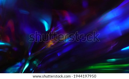 Defocused metallic dark blue green and purple light leaks. Festive neon abstract holographic modern background for party. Blurred glow