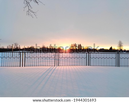 Winter sunset in the countryside with a view of the houses