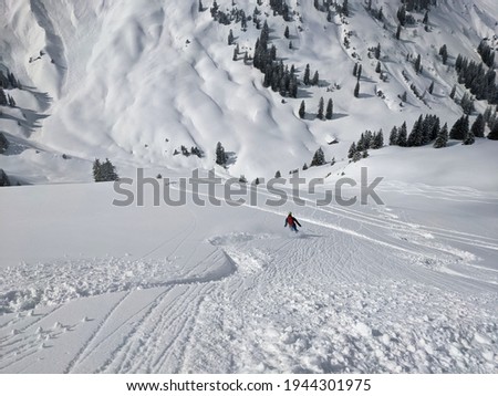 Downhill fun in deep powder snow with the free touring skis in the mountains of glarus. Winter landscape. mountaineering Royalty-Free Stock Photo #1944301975