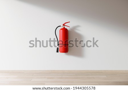 Red fire extinguisher isolated indoors on the wall, personal fire protection, home fire extinguisher, template or source