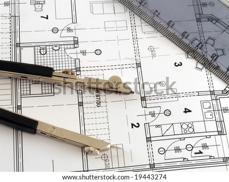 dividers and ruler laying on architectural plan