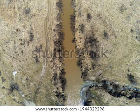 Dirty Olt river at springtime aerial drone view in Transylvania, Romania.