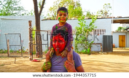 Peoples celebrating Indian color festival called HOLI. Face color shot on auspicious festival of Holi or Rangpanchmi. Royalty-Free Stock Photo #1944357715