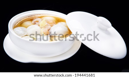 Rice flour dumpling in ginger syrup, Chinese traditional cuisine isolated on black background  Royalty-Free Stock Photo #194441681