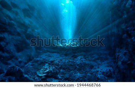 Underwater photo of magic sunlight inside a cave. From a scuba dive in the Red sea in Egypt.