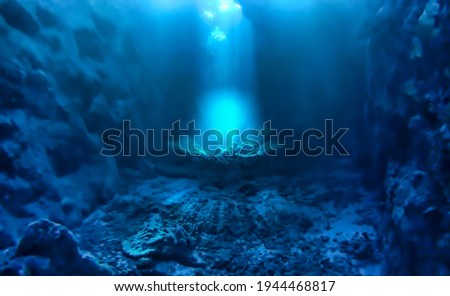 Underwater photo of magic sunlight inside a cave. From a scuba dive in the Red sea in Egypt.