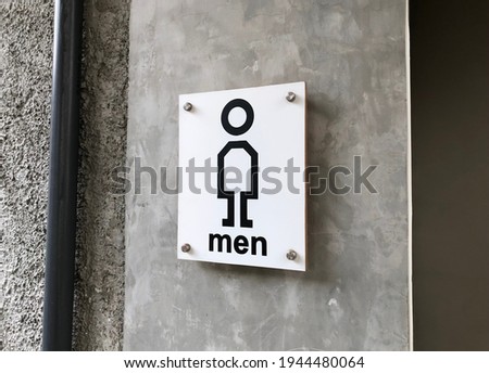A picture Toilet sign taken during the daylight