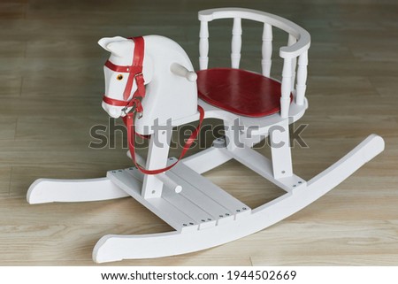  White wooden rocking horse chair. Children's toy