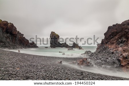 Long exposure of Icelandic Beach with stones instead of sand.