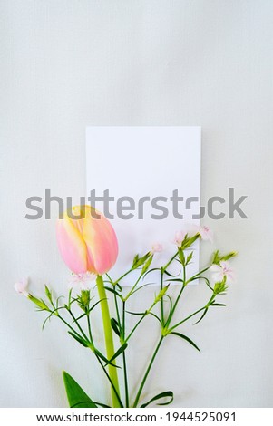 Mockup of tulips, dianthus and rectangular white cards, placed vertically