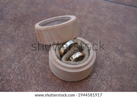 Wedding rings in beautiful wooden jewelry box with glass window on top on ceramic surface celebration of love happy day for loved hearts