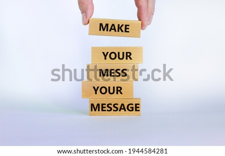Business concept growth success process. Wood blocks on white background, copy space. Businessman hand. Words 'make your mess your message'. Conceptual image of motivation.