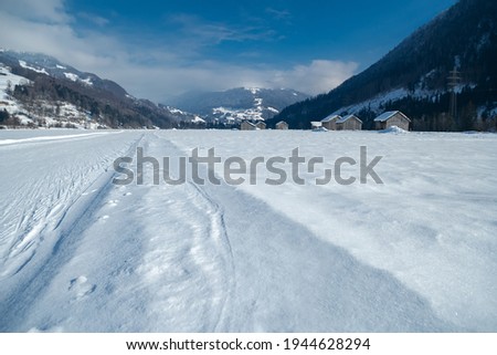 Winter mountain landscape with groomed cross-country trails. Swiss Alps, Switzerland, Europe