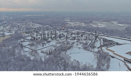 Residential small town snowy during a winter after snow storm on wonderful winter scenery with roof houses covered snow on the aerial view
