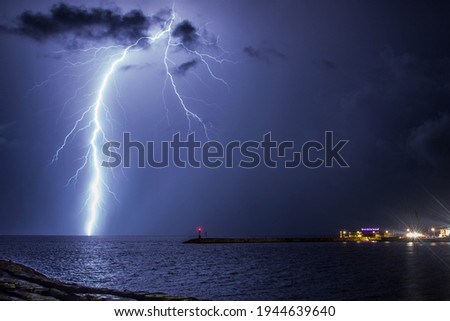 Beautiful lightining Strike, front of Rimini Port! Royalty-Free Stock Photo #1944639640