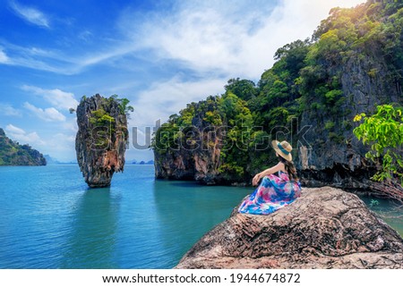 Beautiful girl sitting on the rock at James Bond island in Phang nga, Thailand. Royalty-Free Stock Photo #1944674872
