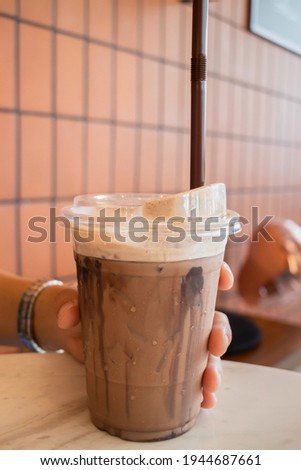 Hand  holding the glass iced cocoa, stock photo