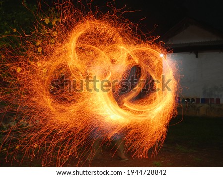 Light Painting Using Sparkling Poi. Capture with low shutter speed. 