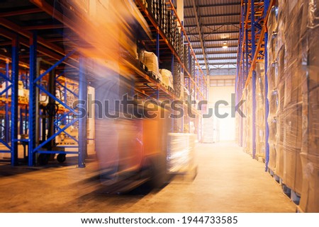 Fast Motion Blur of Forklift Driver Working at The Warehouse.