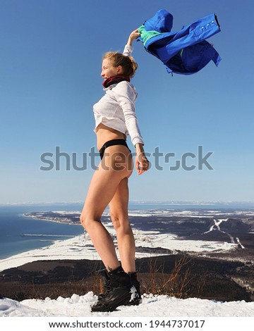Sports girl on the top of the mountain. Trekking in the mountains in winter