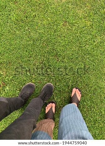 two couples who were walking on the green grass