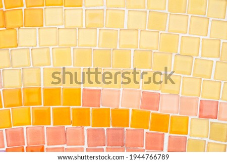 Closeup mosaic tile flooring in orange color tone, abstract mosaic flooring texture