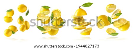 A creative set with Fresh raw whole and cut lemons with green leaves falling in the air isolated on white background. Food levitation or zero gravity conception. High resolution image Royalty-Free Stock Photo #1944827173