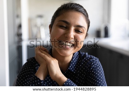 Head shot portrait close up smiling Indian woman making video call, looking at camera, overjoyed young female speaking, chatting online, happy blogger influencer recording vlog, having fun