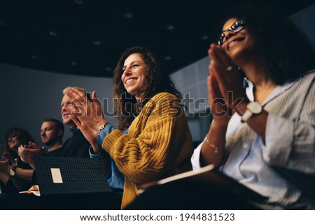 Audience listening to the speech and clapping hands. Group of business people attending a convention applauding during the forum. Royalty-Free Stock Photo #1944831523