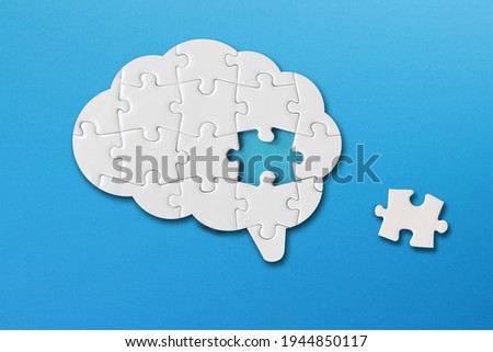 Brain shaped white jigsaw puzzle on blue background, a missing piece of the brain puzzle, mental health and problems with memory	 Royalty-Free Stock Photo #1944850117