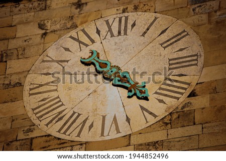 Retro and antique clock made on the wall of a building