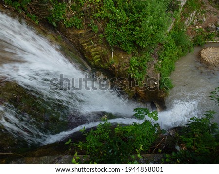 A small waterfall on a fast running stream in the countryside provides an interesting backdrop for fast frame photo shooting
