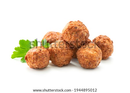 Fried meatballs with a parsley leaf isolated on white background Royalty-Free Stock Photo #1944895012