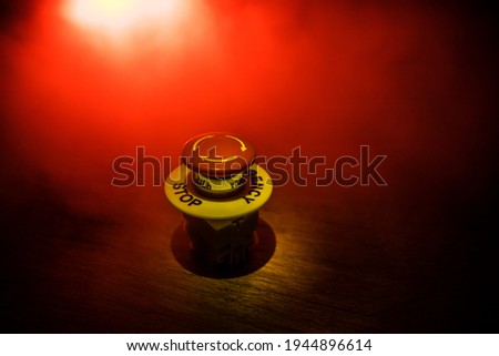 Emergency stop button, Disaster protection. Industrial concept. Red button on table in dark low key background. Selective focus